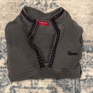 supreme grey half zip with detailing around the collar